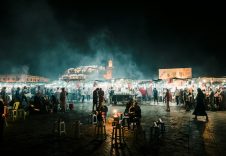 people standing on a beach during night time