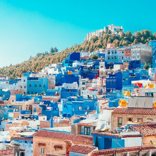 Photo by Heidi Kaden blue and white painted houses on the cliff